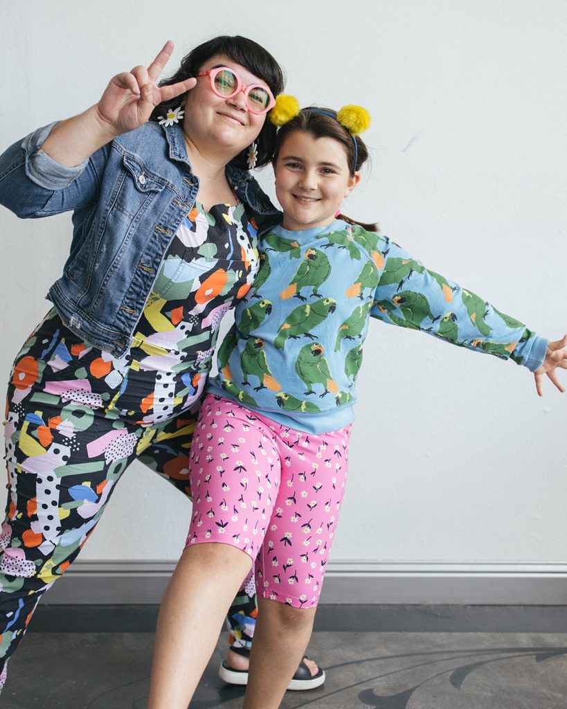 A mother and daughter pose for family photographs while mixing patterns in their outifts