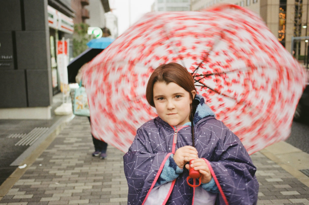 girl twirling umbrella