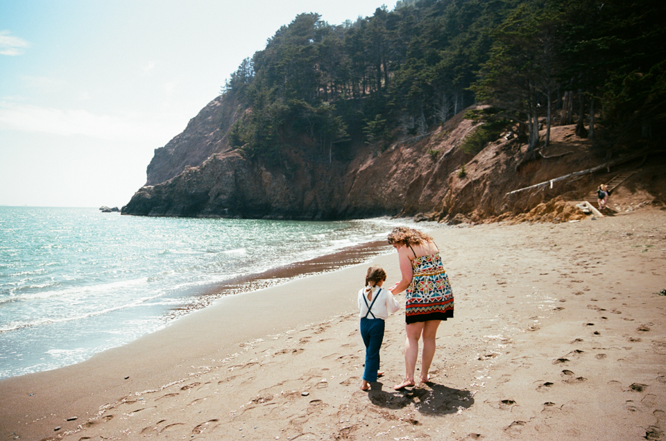 mother and daughter standing on beach in sausalito