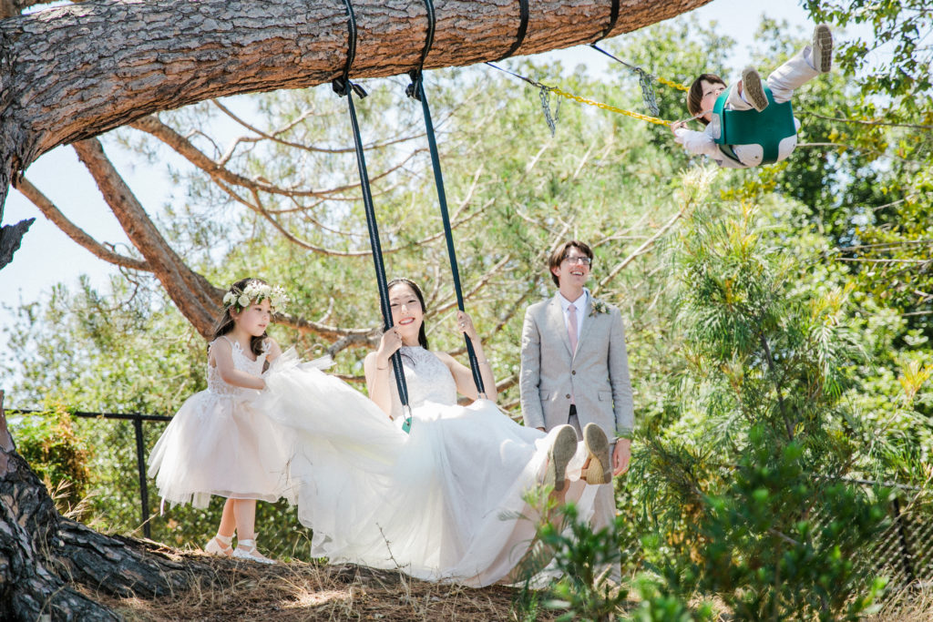 woman in wedding dress on a swing 