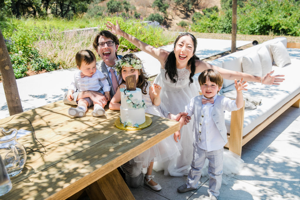 family of 5 at a vow renewal with cake