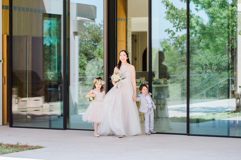 julie zhou in wedding dress with her two children in wedding attire