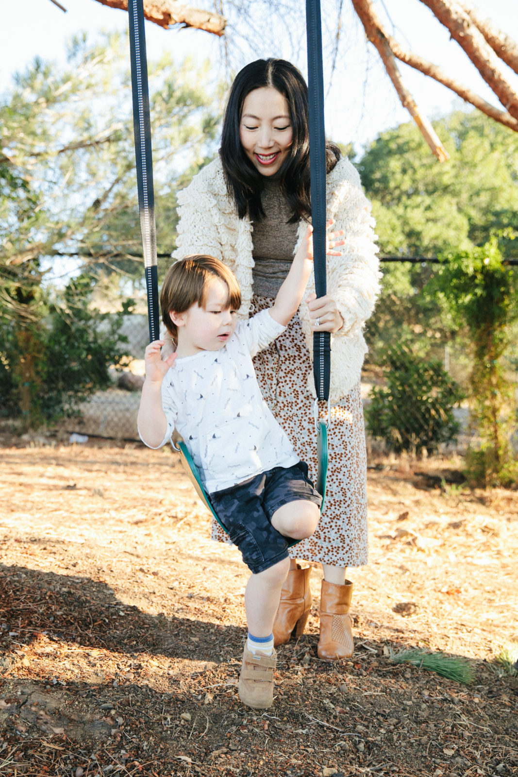 mom helping son with swing