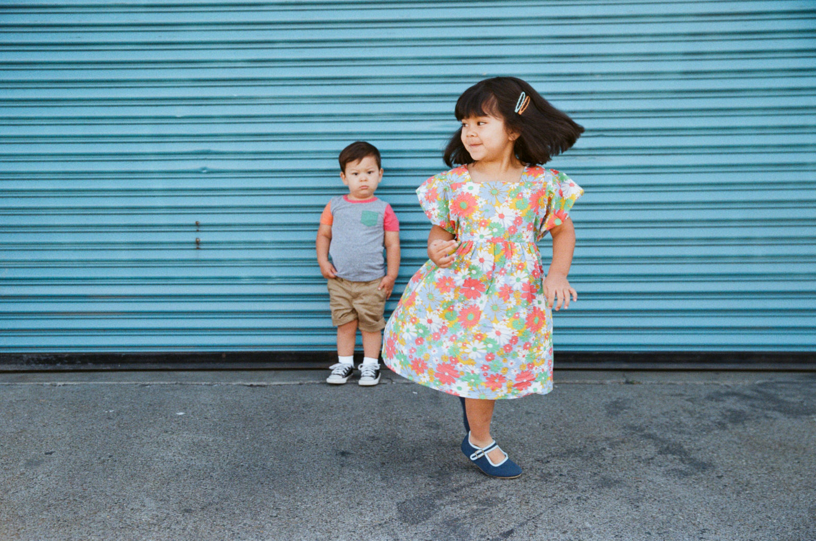toddler boy standing with twirling sister