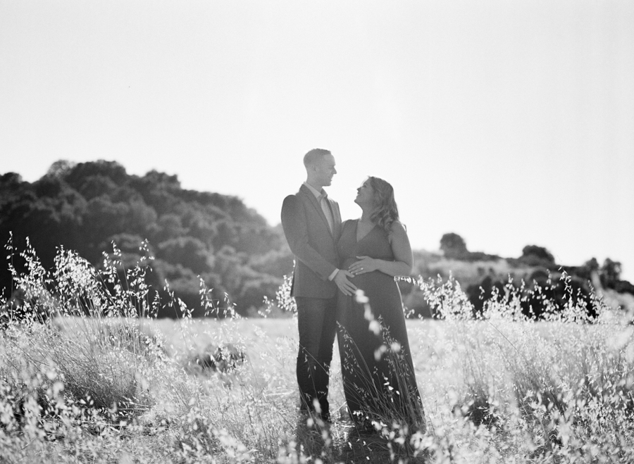 black and white image of husband and pregnant wife at rancho san antonio