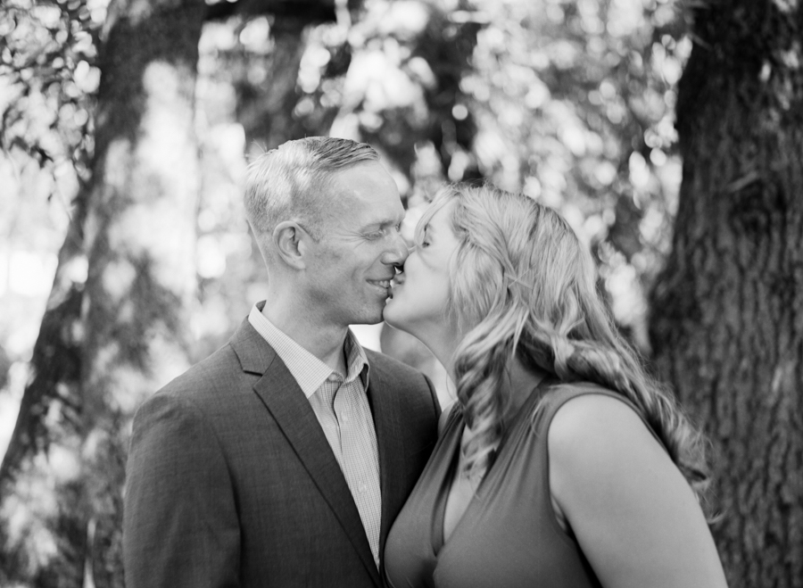 black and white image of husband and wife kissing