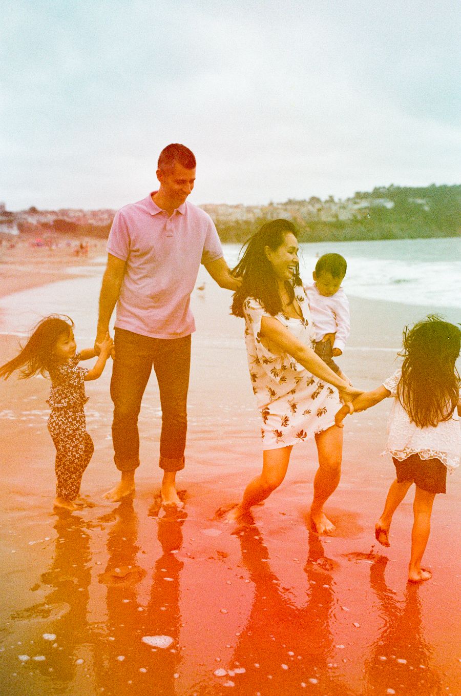 family of 5 on beach in san francisco