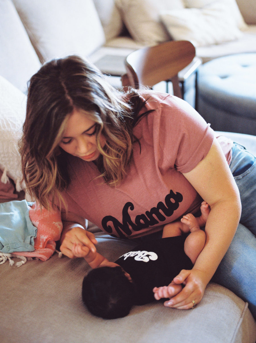 mom in mama shirt leaning over baby in babe onesie