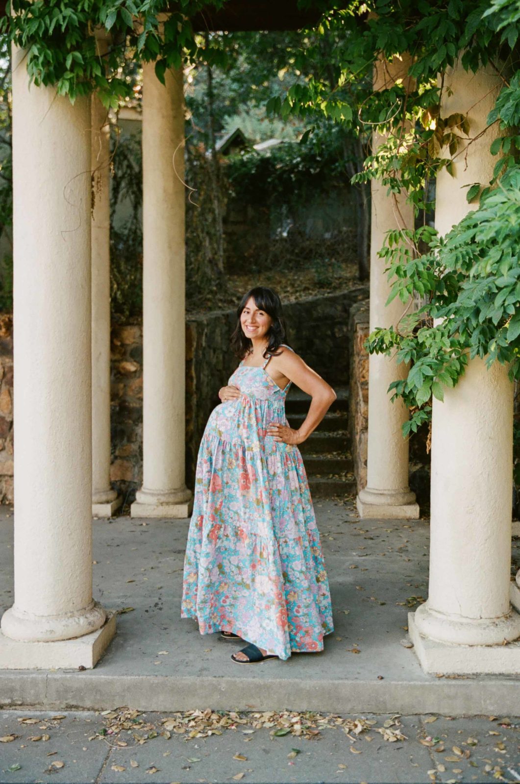 pregnant mother in floral free people dress at Morcom Rose Garden in Oakland