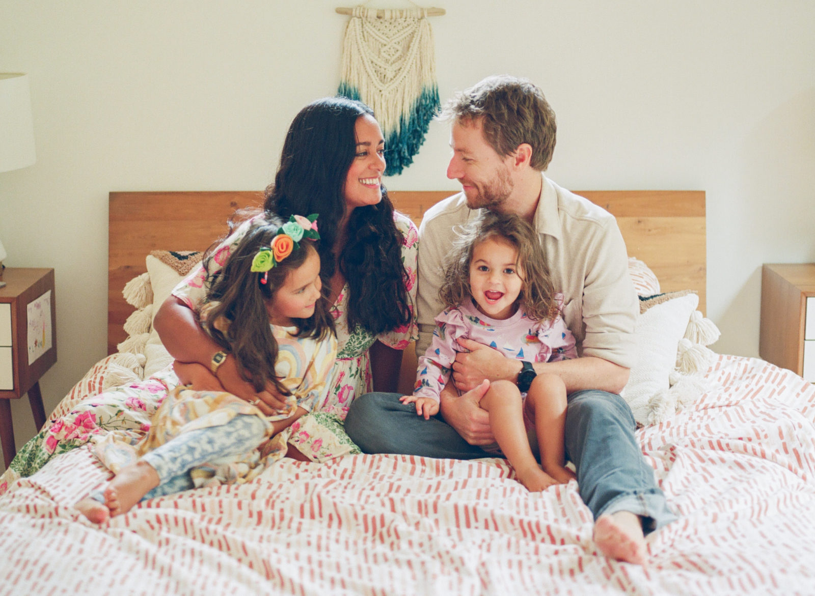 photo of Anjelika Temple with her family of four on a bed
