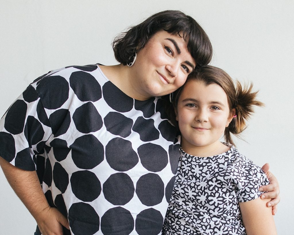 A mother and her daughter dress in mixed black and white monochromatic pattern shirts for a fun and trendy family photo session