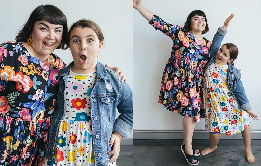 A mother and daughter pose goofily while wearing family photo outfits with mixed prints