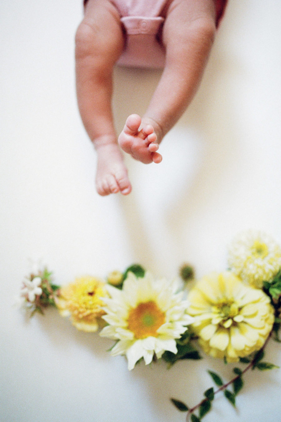 newborn baby toes and floral arrangement